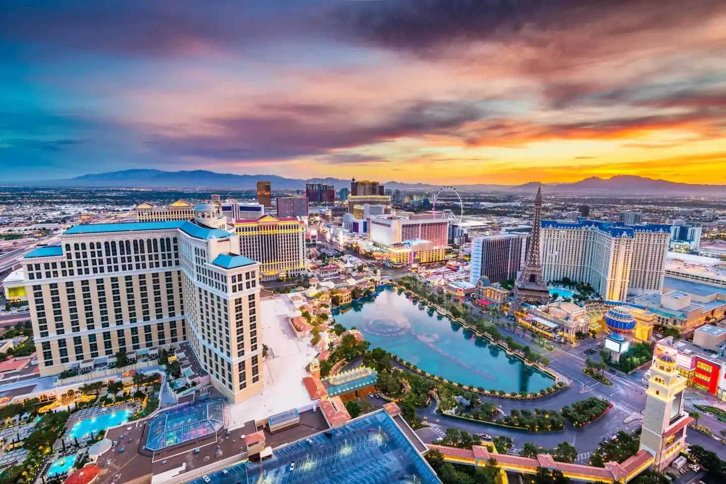 The Las Vegas Strip at dusk with the Bellagio fountains and hotel towers lit up