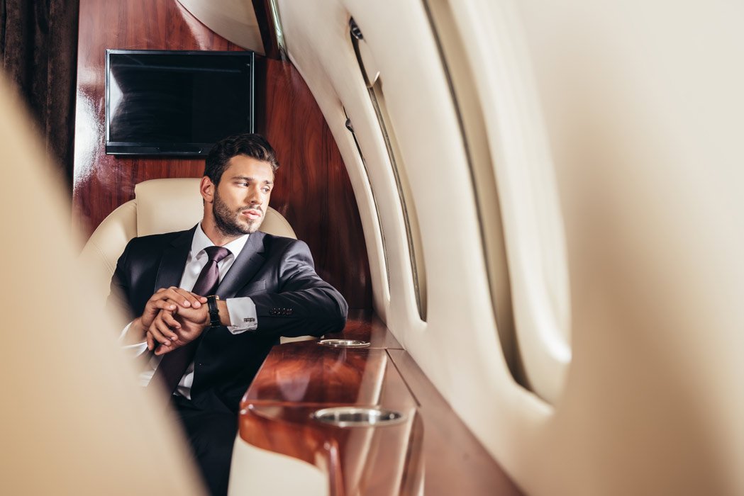 Executive seated in the cabin of a private jet