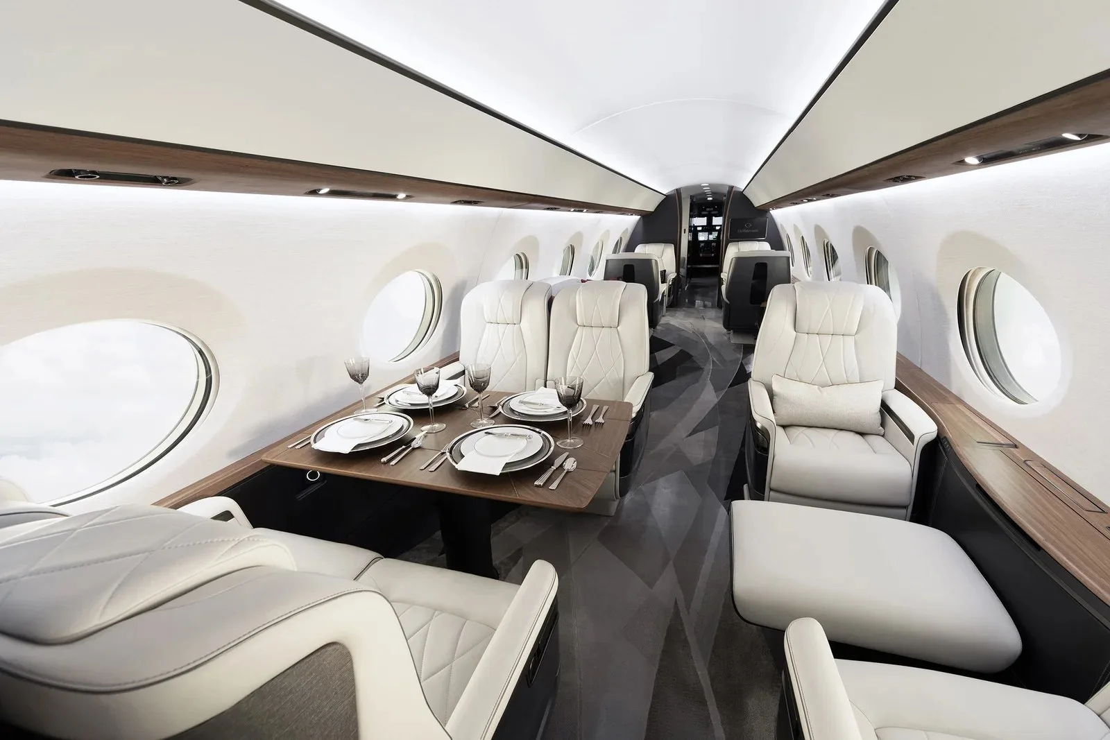 Cabin interior of a large-cabin private jet with the table set for a meal
