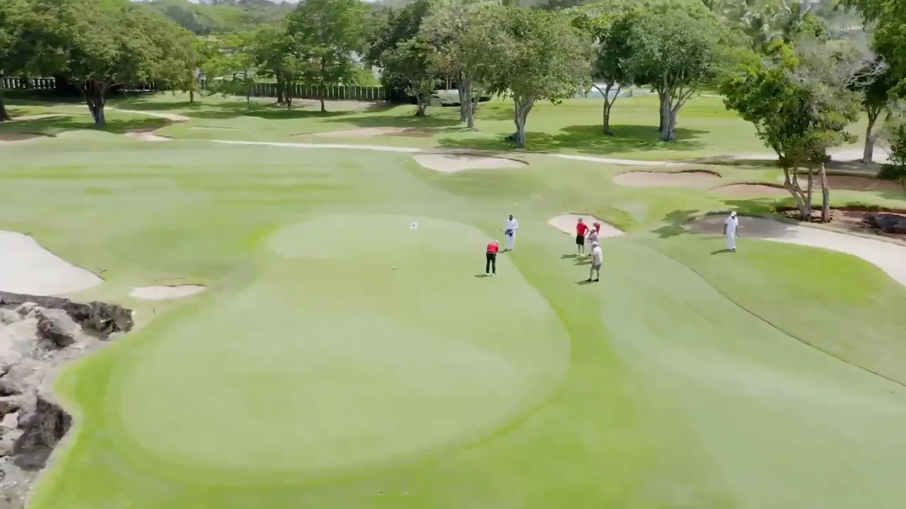 Golfers putting on a tournament green
