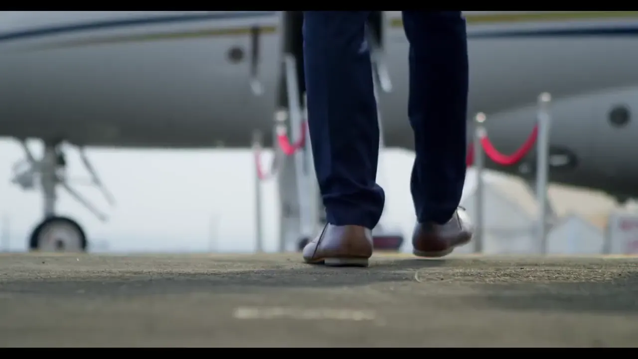 Traveller walking to a private jet with a bag