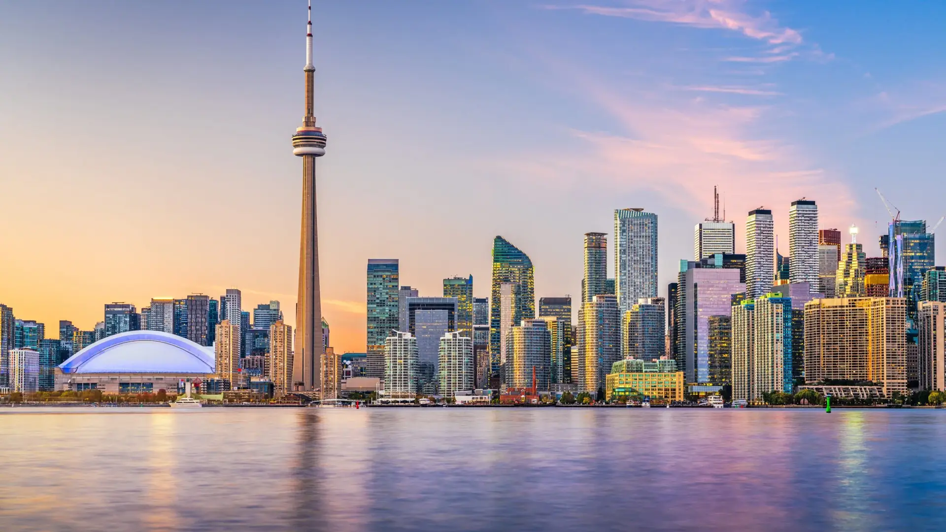 Toronto’s skyline and the CN Tower at dusk, seen across the harbour from the Toronto Islands