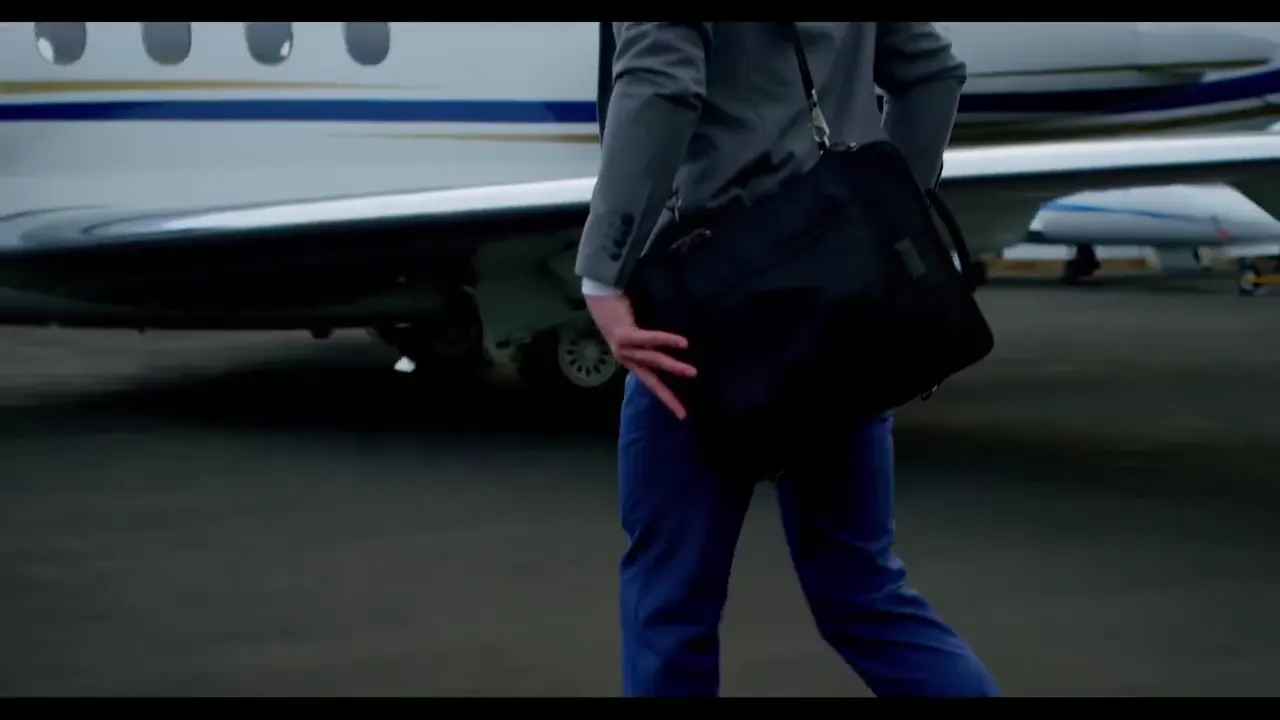 Passenger walking across the ramp to a private jet